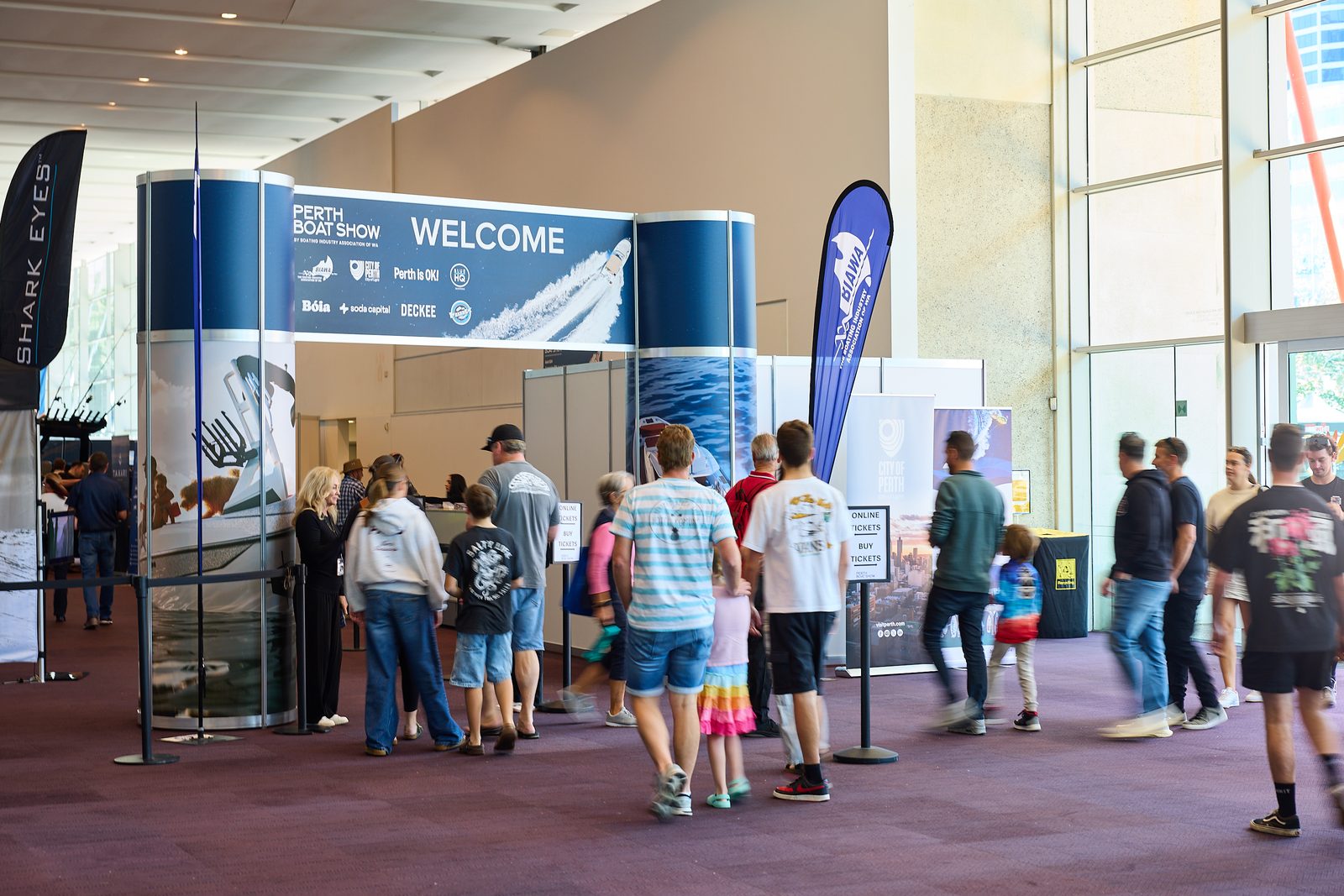 Crowds of visitors walking through the Perth Boat Show entrance archway at the Perth Convention and Exhibition Centre.
